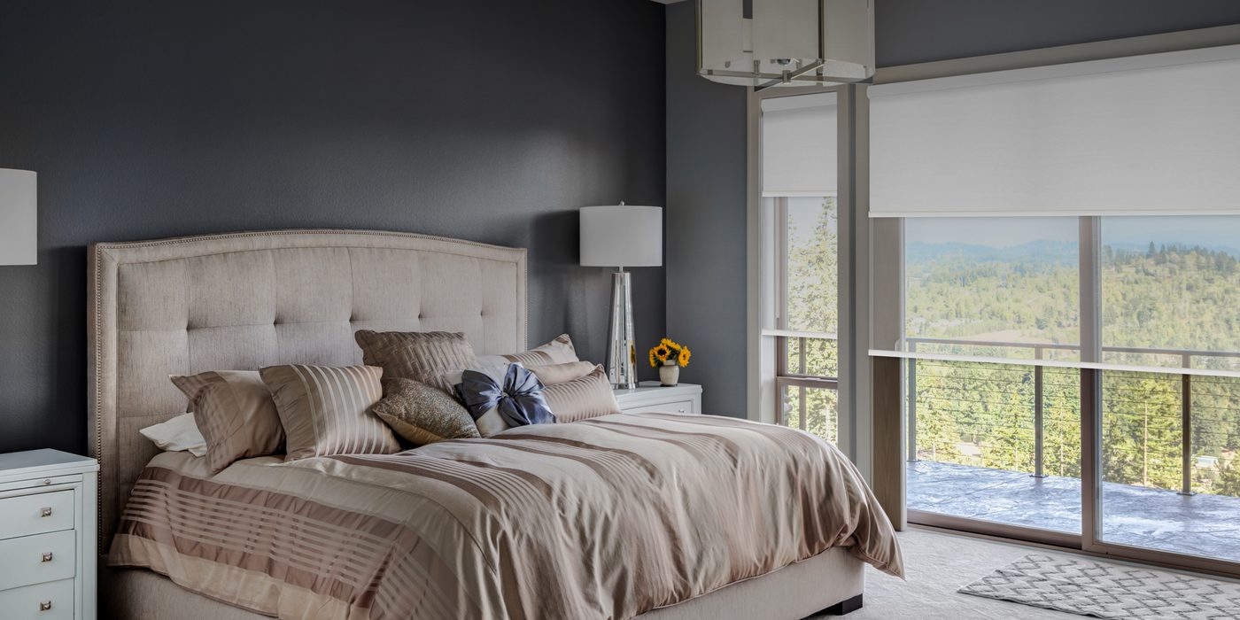 Bedroom with white roller shades