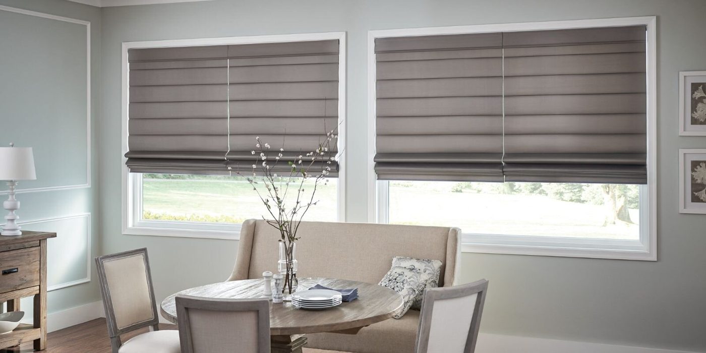 Dining room with gray Roman shades